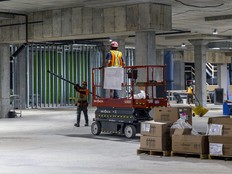 Construction workers in a large indoor space