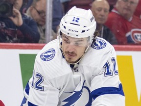 Alex Barré-Boulet wearing a white Tampa Bay Lightning jersey in game action in a close-up photo