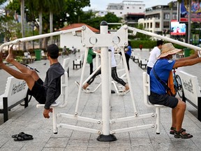 People use exercise equipment at a park in Phnom Penh, Cambodia on June 27, 2024.