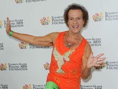 A man in exercise gear poses.