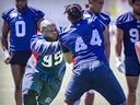 Resilient Alouettes come from behind to defeat Calgary Stampeders 4 Defensive-lineman Derek Wiggan, left, pushes against Domineck Jordan during Alouettes training camp in May.