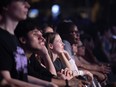 People in the front row of the crowd watch a Jazz Fest show