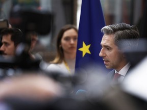 Irish Prime Minister Simon Harris, right, speaks with the media as he arrives for an EU summit at the European Council in Brussels, Monday, June 17, 2024.