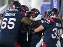 Alouettes running-back Walter Fletcher, centre, celebrates his winning touchdown against the Stampeders with teammates Saturday at Molson Stadium.