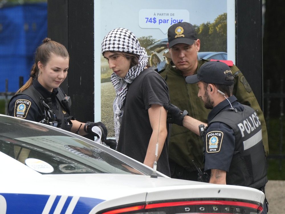 Police detain a protester as security clears the pro-Palestinian encampment at McGill University in Montreal, Wednesday, July 10, 2024.