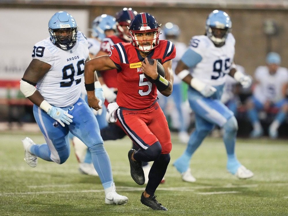 Alouettes quarterback Caleb Evans runs for a first down against the Argonauts in Montreal, July 11, 2024.