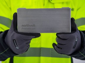 A person holds a mockup of a Northvolt EV battery at the Northvolt Ett gigafactory in Skelleftea, north Sweden