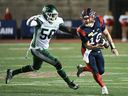 Montreal Alouettes quarterback Davis Alexander (10) breaks away from Saskatchewan Roughriders' Bryan Cox Jr. (50) during second-half CFL football action in Montreal July 25, 2024.