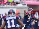 Montreal Alouettes quarterback Cody Fajardo (7) throws to wide receiver Kaion Julien-Grant (11) during first-half CFL football action against the Calgary Stampeders in Montreal on Saturday July 6, 2024.