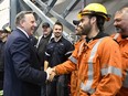 Quebec Premier Francois Legault greets workers at the inauguration of La Romaine hydroelectric plant in Havre St-Pierre in October. Since 1990, Quebec has cut its total emissions by 8.9 per cent, but greenhouse gases from transportation have climbed 16 per cent. Jacques Boissinot /