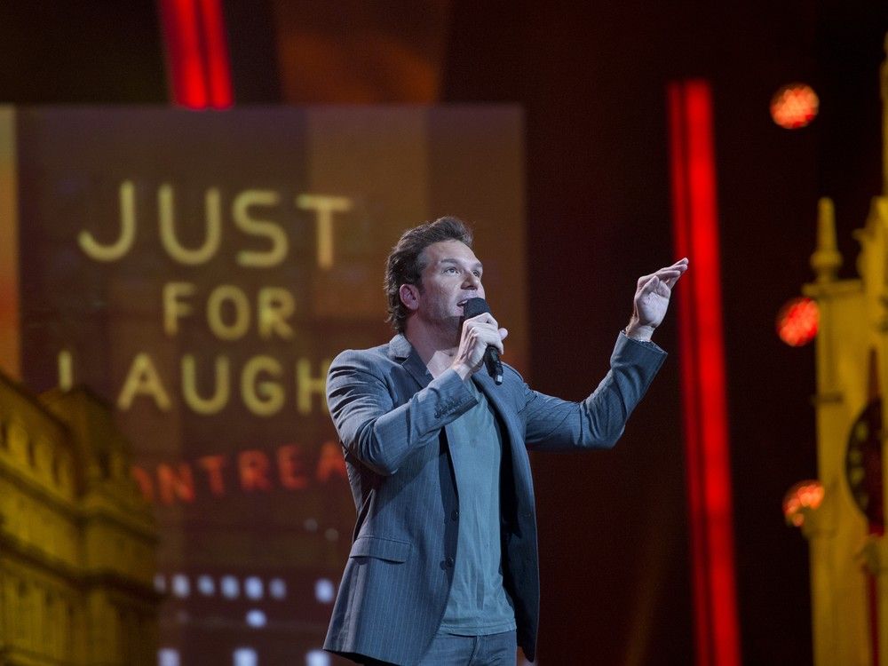 Comic Dane Cook gestures while speaking into a microphone on stage at a Just for Laughs event in Montreal.