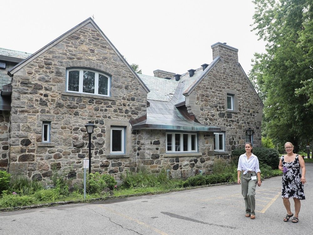 Sarah-Jane Boivin, left, communications manager at Ricochet Centre, the only homeless shelter between downtown Montreal and Vaudreuil, walks with resident Marie-France Dubuc at the new location in Pierrefonds on Thursday. Ricochet relocated after being forced to close its doors in May. John Kenney / MONTREAL GAZETTE