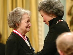 Two women face each other, smiling.