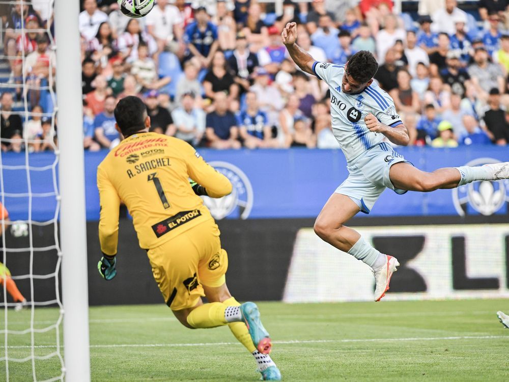 CF Montreal's Matias Coccaro (9) scores against Atletico de San Luis goalkeeper Andres Sanchez during first half Leagues Cup soccer action in Montreal, Tuesday, July 30, 2024.