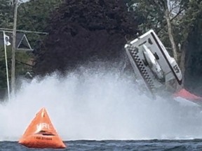 A racing boat flips in the water
