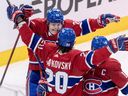 Canadiens' Cole Caufield leaps into teammate Juraj Slafkovsky's arms after the latter scored during the final game of last season. Captain Nick Suzuki's face is obscured.