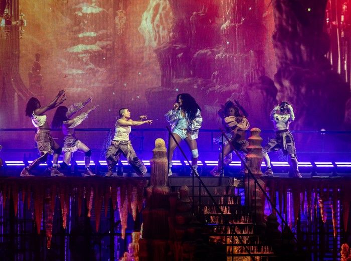 SZA performing with backing dancers on a festival stage