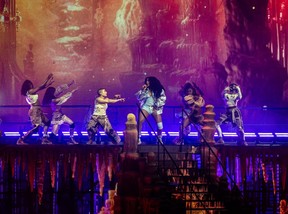 SZA performing with backing dancers on a festival stage