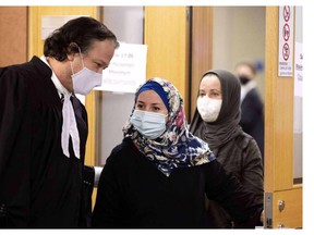 Frédéric Bérard speaks with clients in court on Nov. 3, 2020.