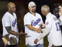 Former Expos manager Felipe Alou shakes hands with Larry Walker and Cliff Floyd, left, as members of the 1994 Expos were introduced before a pre-season game at Olympic Stadium in 2014.