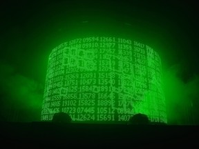 A cylindrical digital display shows a series of five-digit numbers in green script.