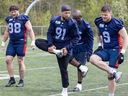 Alouettes defensive lineman Isaac Adeyemi-Berglund, No. 91, works out with Dylan Wynn, left, Derek Wiggan and Brock Gowanlock, right, during training camp in May.