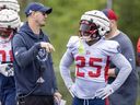 Alouettes head coach Jason Maas speaks with running-back Walter Fletcher during training camp practice in St-Jérôme this past May.
