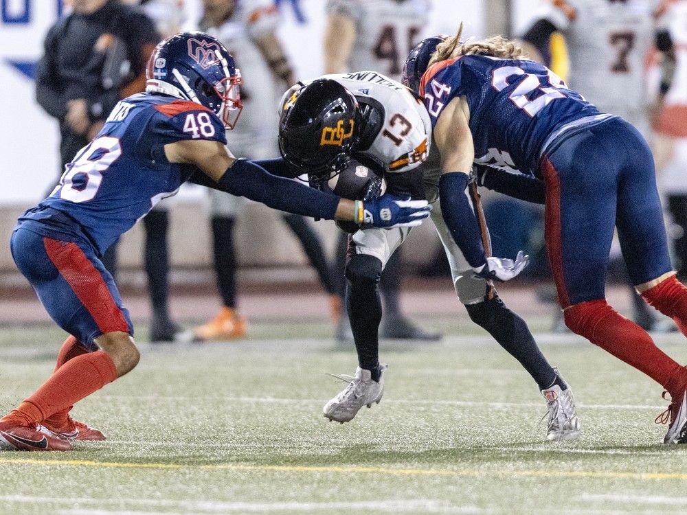 Alouettes' Kabion Ento, left, and Marc-Antoine Dequoy team up to stop Lions receiver Alexander Hollins during game last week at Molson Stadium.