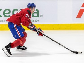 Hockey player Florian Xhekaj skates on the ice with the puck