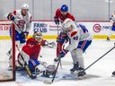 Lane Hutson (#48) and and Luke Tuch (#88) scramble for the loose puck during Canadiens rookie camp in Brossard on Thursday.