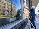 Maintenance workers board up broken windows at Concordia University's Hall Building in Montreal Monday Sept. 30, 2024. The windows were smashed during a pro-Palestinian demonstration Sunday evening.