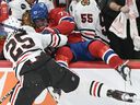 Montreal Canadiens' Kirby Dach is dumped into the Chicago Blackhawks bench by Jarred Tinordi at the Bell Centre on Saturday, Oct. 14, 2023. Dach suffered a season-ending knee injury in the incident.