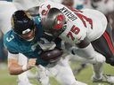 Buccaneers' Lwal Uguak sacks Jaguars QB C.J. Beathard during NFL pre-season game in August. In three exhibition games with the Bucs, Uguak had two tackles, a sack and knocked down a pass.