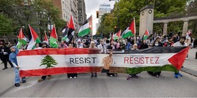 Pro-Palestinian protesters march outside McGill University's Roddick Gates in Montreal on Monday, Oct. 7, 2024.