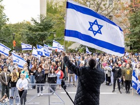 Reverand Hazan Daniel Benlolo waves an Israeli flag during pro-Israel rally