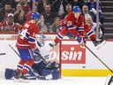 Montreal Canadiens' Juraj Slafkovsky jumps out of the way of a shot in front of Toronto Maple Leafs goalie Anthony Stolarz as Nick Suzuki waits for a rebound during the second period of a National Hockey League game in Montreal Wednesday Oct. 9, 2024.