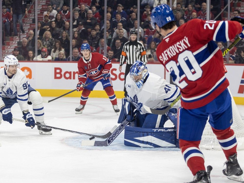 Montreal Canadiens' Juraj Slafkovsky passes the puck past Toronto Maple Leafs defenceman Oliver Ekman-Larsson and goalie Anthony Stolarz to a waiting Cole Caufield, rear, who converted the pass into the Habs' first goal of the new season during the first period at the Bell Centre in Montreal Wednesday Oct. 9, 2024.
