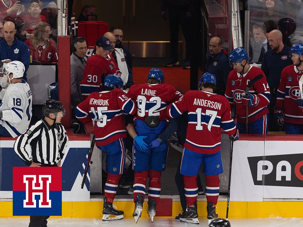 Montreal Canadiens' Patrik Laine is helped off the ice by teammates following a collision with a Toronto Maple Leas player on Sept. 28, 2024.