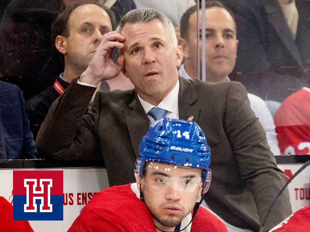 Montreal Canadiens coach Martin St. Louis and captain Nick Suzuki watch the dying seconds of National Hockey League game against the Tampa Bay Lightning in Montreal on April 4, 2024.