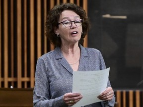 Politics tamfitronics Louise Chabot speaks in the House of Commons while holding a sheet of paper