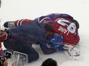 Canadiens' Patrik Laine is attended to by a trainer after a collision with a Maple Leafs player Saturday night at the Bell Centre.
