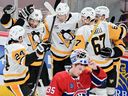 Pittsburgh Penguins' Kris Letang (58) celebrates with teammates after scoring against Montreal Canadiens goaltender Sam Montembeault (35) during third period NHL hockey action against the in Montreal, Monday, Oct. 14, 2024.