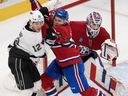 Montreal Canadiens' Jake Evans (centre) tries to move Los Angeles Kings' Trevor Moore (12) from in front of Canadiens goaltender Sam Montembeault (35) during second period NHL hockey action Thursday, Oct. 17, 2024 in Montreal.