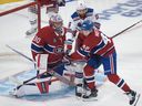 New York Rangers' Vincent Trocheck (16) battles Montreal Canadiens' Lane Hutson (48) for a loose puck in front of Canadiens goaltender Cayden Primeau (30) during second period NHL hockey action Tuesday, Oct. 22, 2024 in Montreal.