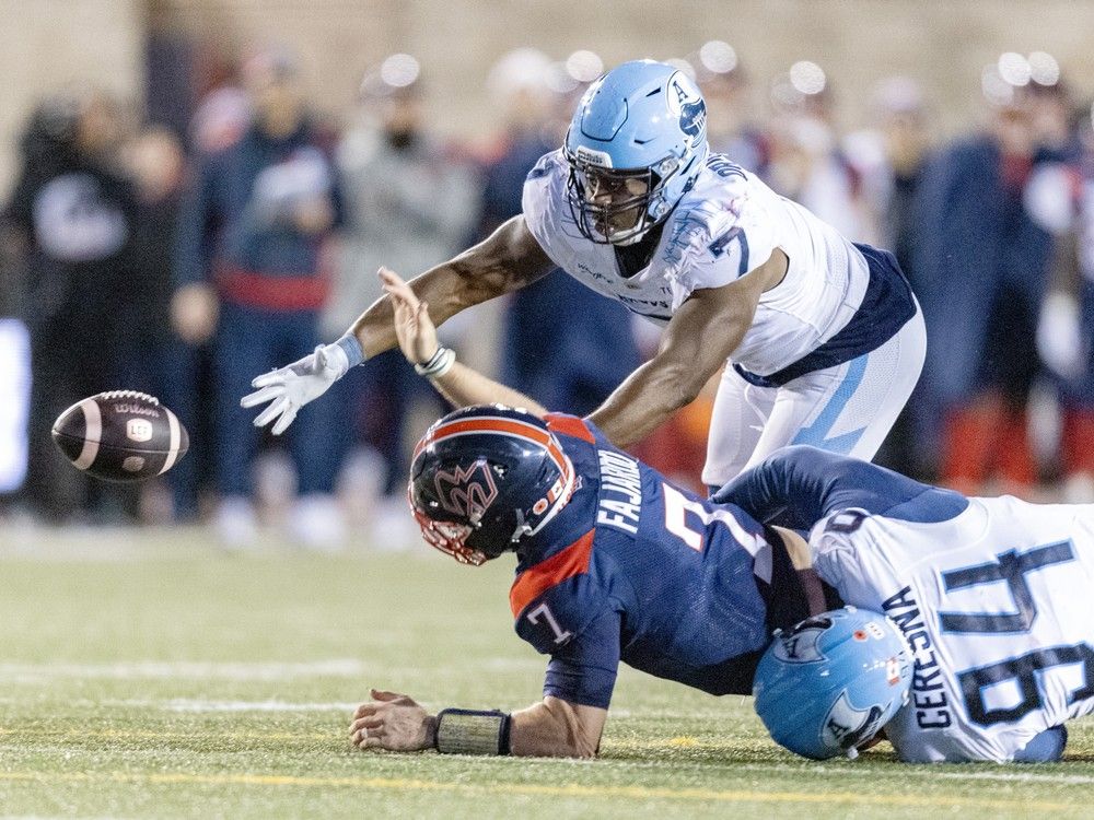 Alouettes quarterback Cody Fajardo fumbles the football while being tackled by Argonauts' Jake Ceresna and Folarin Orimolade Saturday afternoon at Molson Stadium. The play was one of six turnovers on the day for Montreal.