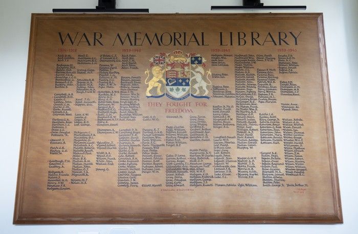  a wooden plaque shows the names of hudson’s world war veterans at the hudson war memorial library.