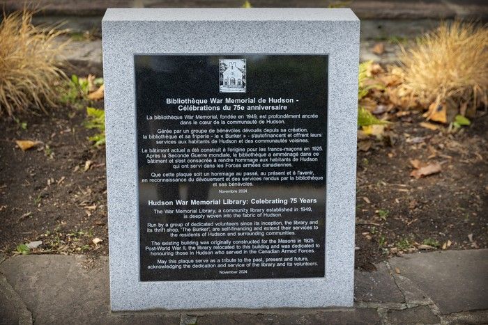  a monument commemorates the hudson war memorial library’s 75th anniversary.