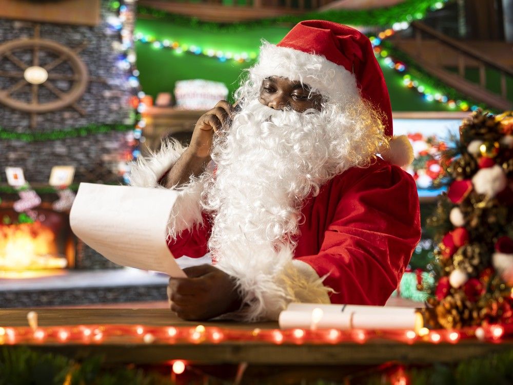 santa claus reading letters by the fire