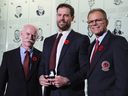 Lanny McDonald (l) and Mike Gartner (r) present Shea Weber with his Hall ring during a media availability at the Hockey Hall of Fame on Nov. 8, 2024 in Toronto. The Class of 2024 will be inducted into the Hall of Fame on Nov. 11.