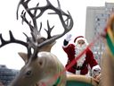 Santa waves to the crowd atop his sleigh at Montreal's Santa Claus Parade's 72nd instalment on Saturday, Nov. 23, along René-Lévesque Blvd.
